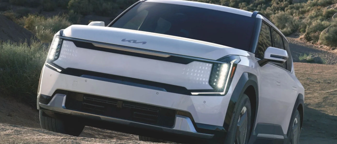 The 2024 Kia EV9 driving up a hill